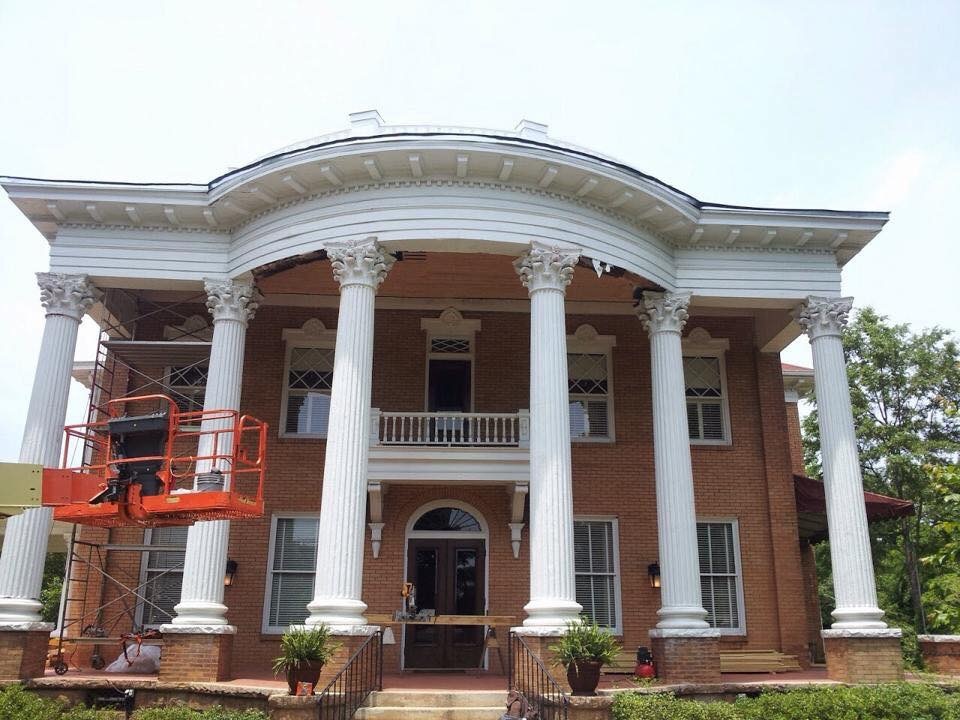 A house pillar being painted white.